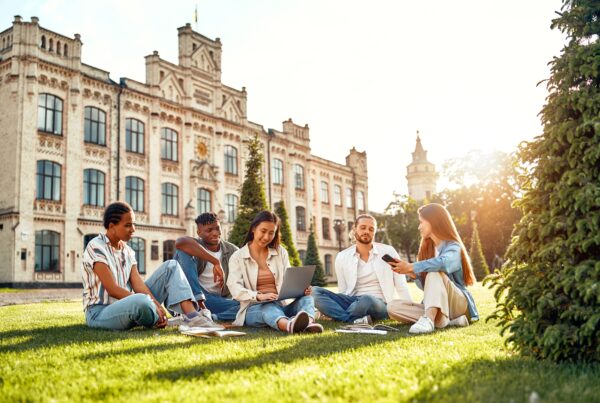 University Students sitting happily on the campus quad.